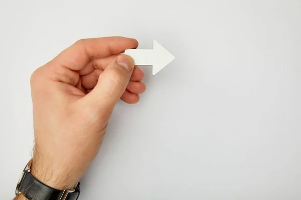 Cropped view of man holding white pointer on grey background — Stock Photo