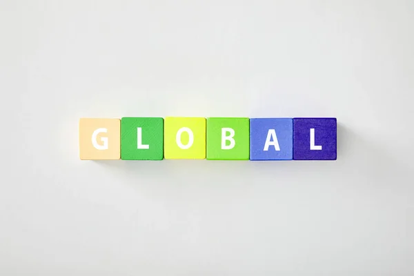 Top view of global made of multicolored cubes on grey background — Stock Photo