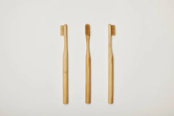 Top view of bamboo toothbrushes on white background — Stock Photo