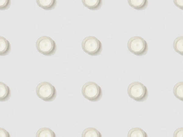 Containers cosmetic cream on grey background, seamless background pattern — Stock Photo