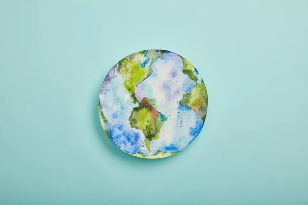 Top view of planet picture on turquoise background, earth day concept — Stock Photo