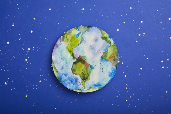 Top view of planet picture on violet background with stars, earth day concept — Stock Photo