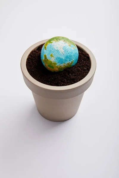 Planet model placed on flowerpot with soil, earth day concept — Stock Photo