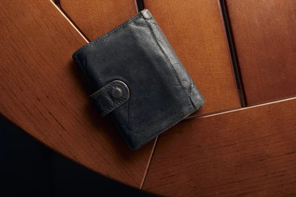 Top view of leather grey wallet on wooden table — Stock Photo