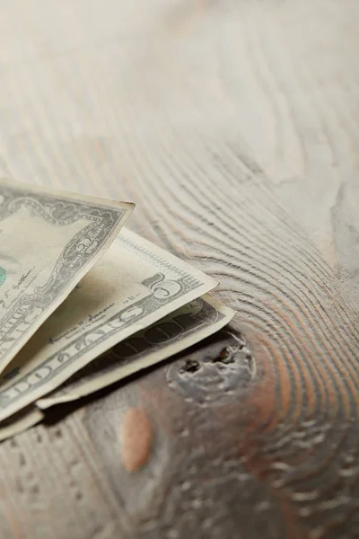 Dollar banknotes on wooden and brown surface with copy space — Stock Photo