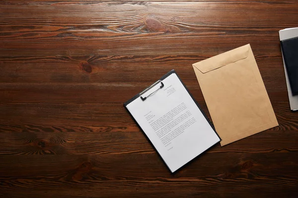 Top view of documet on clipboard and envelope with copy space — Stock Photo