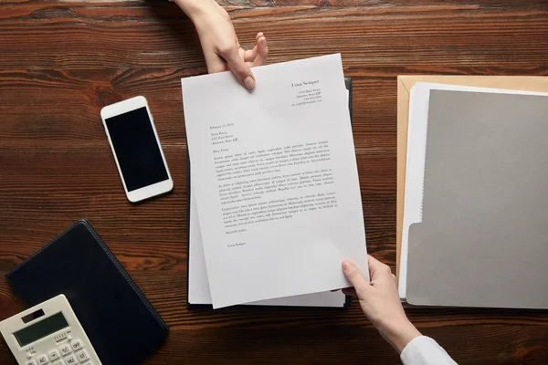 Top view of businesspeople holding contract at workplace with copy space — Stock Photo
