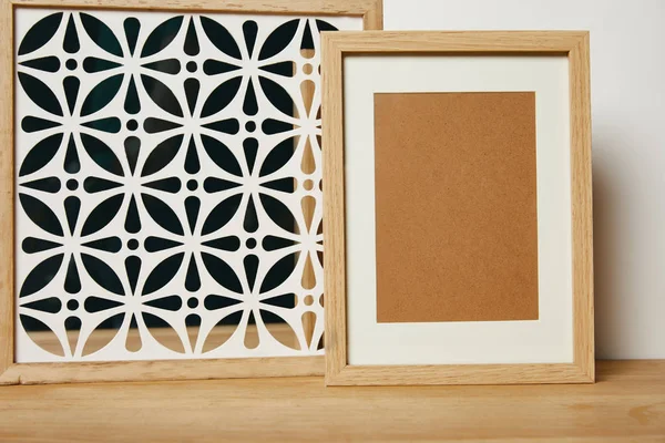 Blank frame near decorative ornate frame on table — Stock Photo