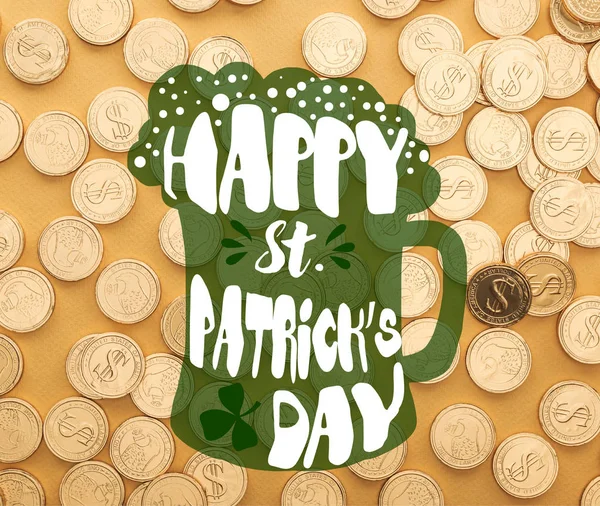 Top view of shiny golden coins with dollar signs near happy st patrick day lettering on orange background — Stock Photo