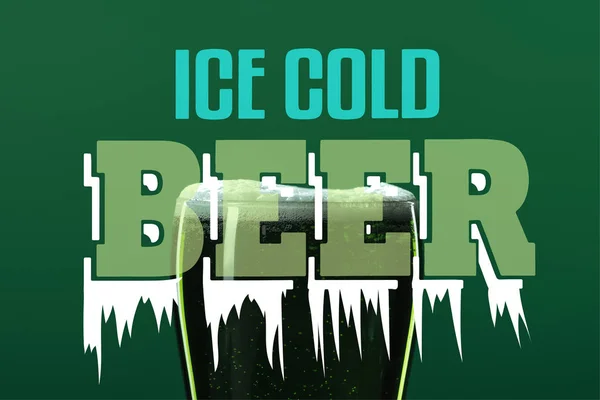 Glass of beer with foam with ice cold beer lettering on green background — Stock Photo