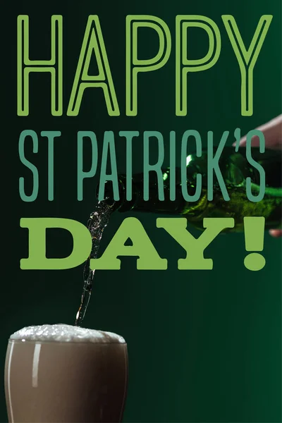 Beer pouring into glass with happy st patricks day lettering on green background — Stock Photo