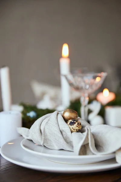 Selective focus of quail eggs on napkin and crystal glass on wooden table at home — Stock Photo