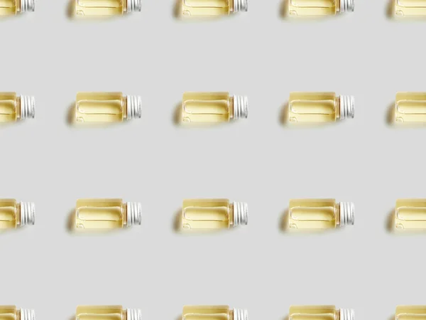 Top view of bottles with essential oil on grey background — Stock Photo