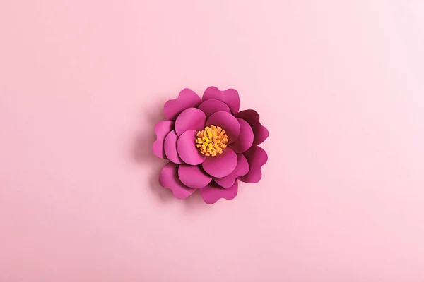 Top view of paper flower on pink background — Stock Photo