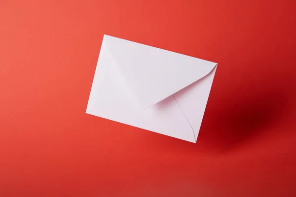 White and empty envelope on red bright background with copy space — Stock Photo