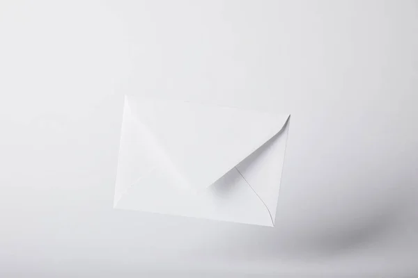 Blank and white envelope on grey background with copy space — Stock Photo