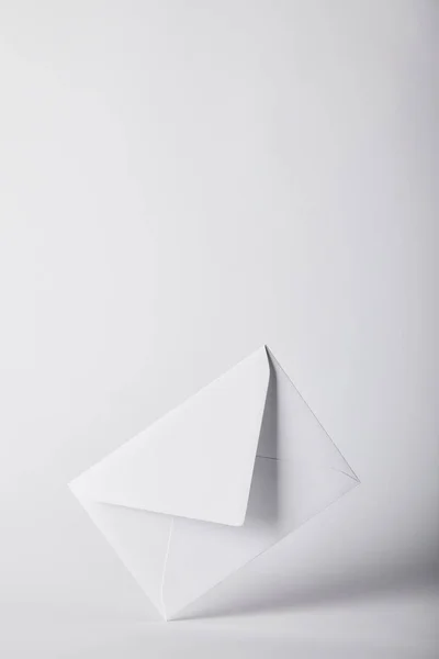 White and empty envelope on grey background with copy space — Stock Photo