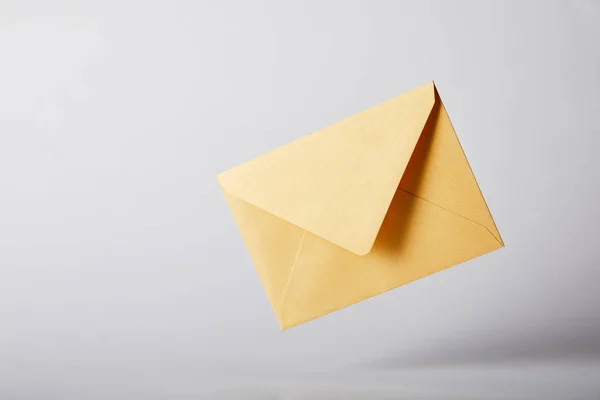 Yellow and bright envelope on grey background with copy space — Stock Photo