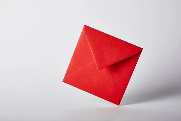 Red and bright envelope on grey background with copy space — Stock Photo