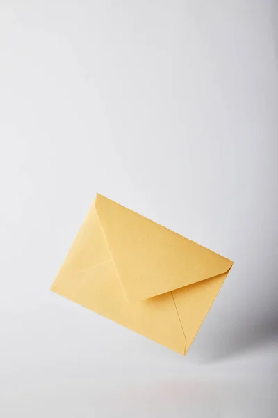 Yellow and bright envelope on grey background with copy space — Stock Photo