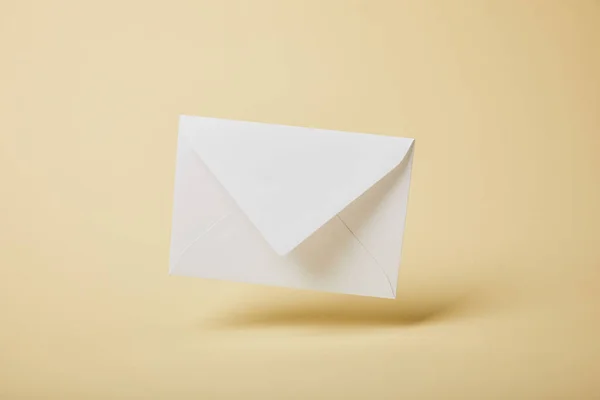 White and empty envelope on yellow background with copy space — Stock Photo