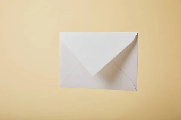 White and empty envelope on yellow background with copy space — Stock Photo