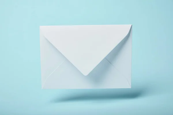 White and empty envelope on blue background with copy space — Stock Photo