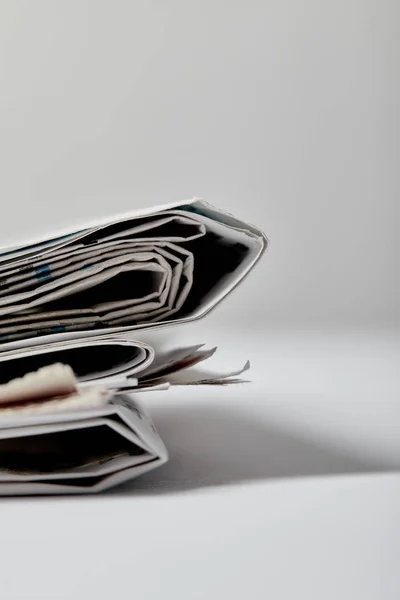 Selective focus of newspapers with copy space on grey — Stock Photo