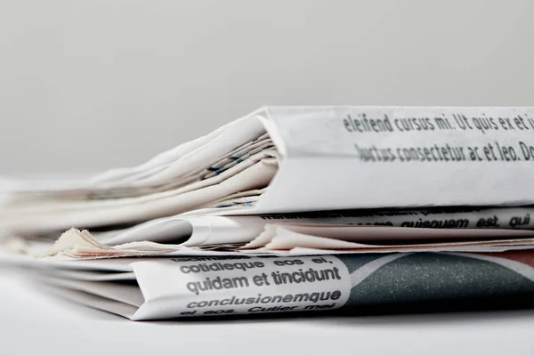 Selective focus of newspapers with lettering on grey — Stock Photo