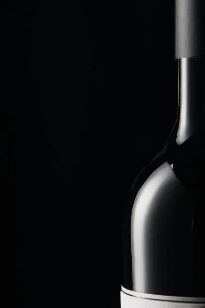 Glass bottle of wine with label isolated on black — Stock Photo