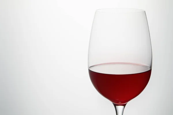 Wine glass with burgundy red wine on white — Stock Photo