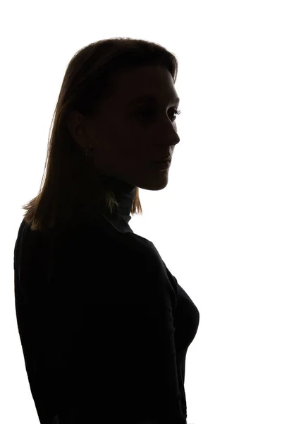 Silueta de mujer pensativa mirando hacia otro lado aislada en blanco - foto de stock
