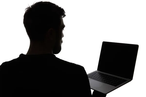 Silhouette de l'homme tenant ordinateur portable avec écran blanc isolé sur blanc — Photo de stock