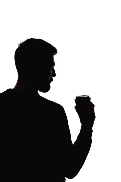 Silhueta de homem segurando xícara de papel de café isolado em branco — Fotografia de Stock
