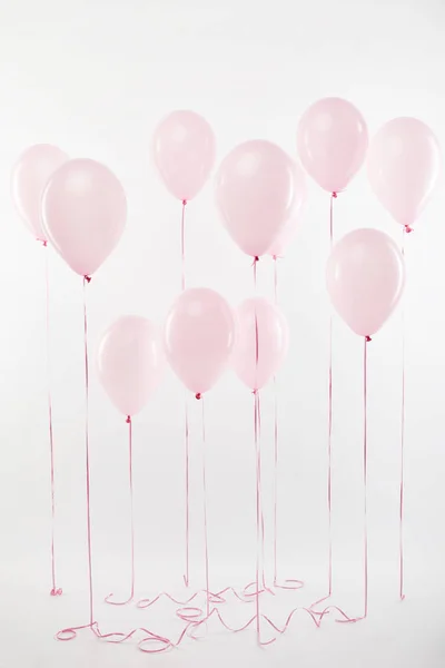 Background with decorative floating pink air balloons on white — Stock Photo