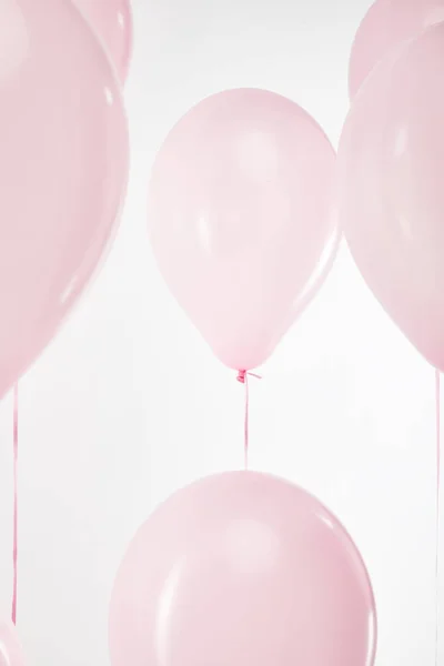 Background with festive floating pink air balloons isolated on white — Stock Photo