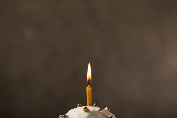 Selective focus of traditional easter cake with burning candle, frosting and sprinkles — Stock Photo