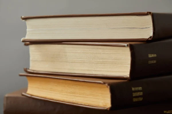 Old brown books with yellow pages isolated on grey — Stock Photo