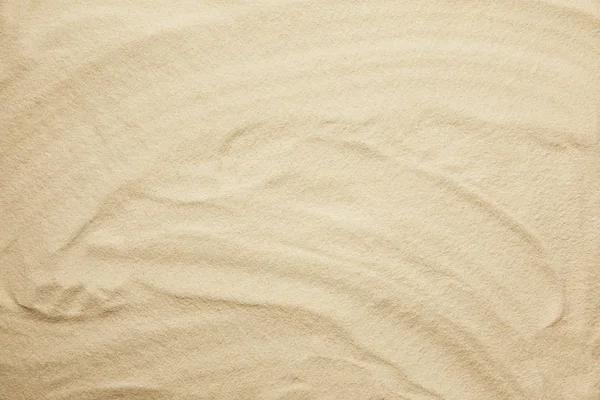 Wavy, golden and textured sandy beach in summertime — Stock Photo