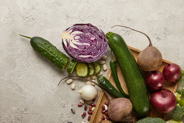 Top view of vegetables and beans on wooden tray — Stock Photo