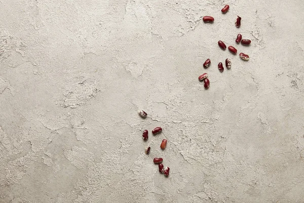 Top view of red beans on grey textured surface — Stock Photo