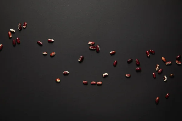 Top view of red beans on black surface — Stock Photo