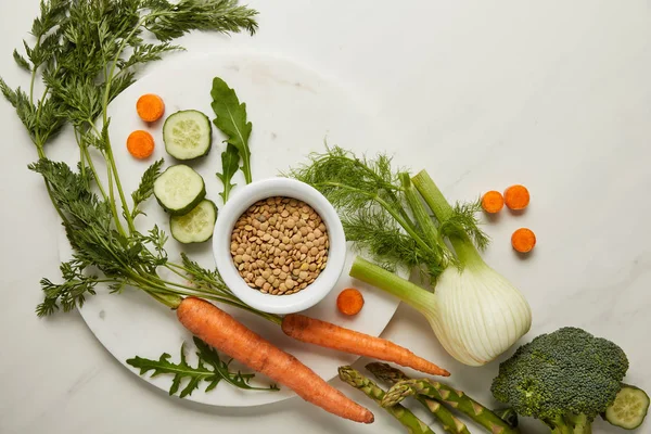 Flat lay with whole and cut vegetables on white surface — Stock Photo