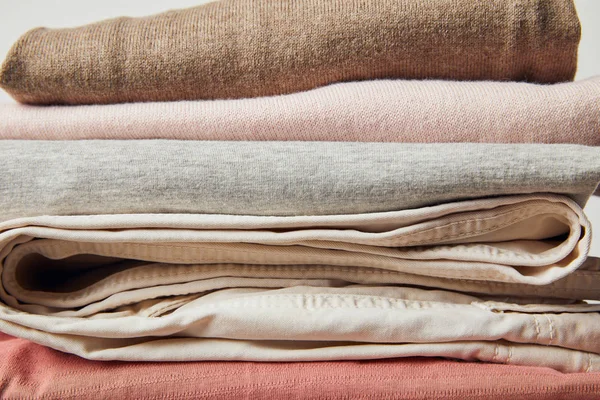 Close up view of stack of folded ironed clothes on grey — Stock Photo