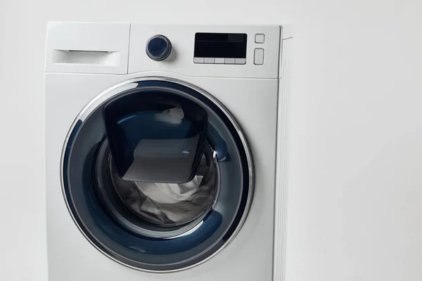 Modern washing machine with black display isolated on grey — Stock Photo