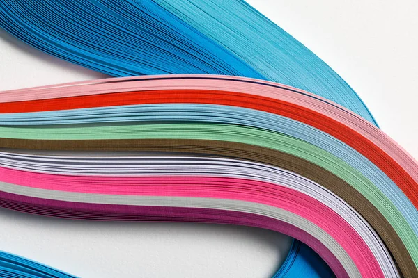 Close up of wavy multicolored rainbow paper lines on grey background — Stock Photo
