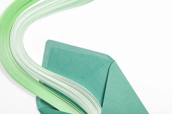 Close up of green envelope with multicolored rainbow on white background — Stock Photo