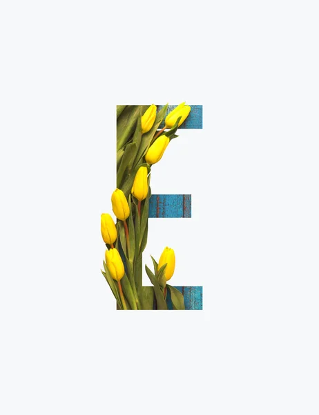 Cyrillic letter with yellow tulips isolated on white — Stock Photo