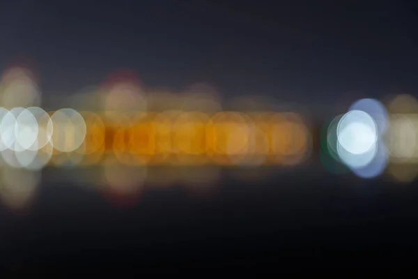 Blurred bokeh lights of city at nighttime — Stock Photo