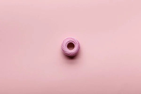 Top view of cotton knitting yarn ball on pink with copy space — Stock Photo